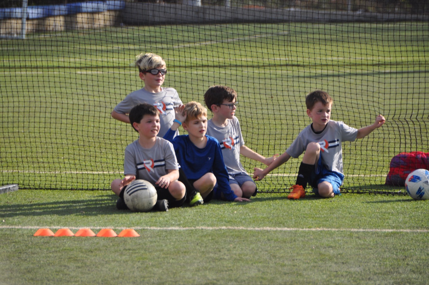 Young players resting by the goal